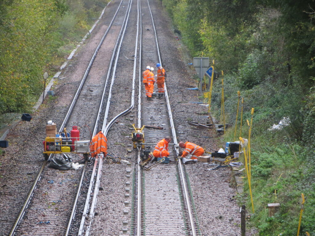 Railroad workers working on train tracks